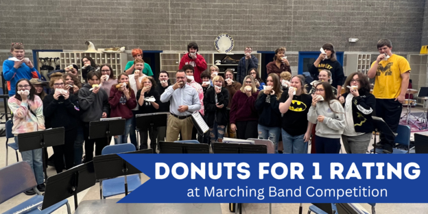 Band Students Receive donuts from Mr.Cole for 1 Rating at Marching Band Competition